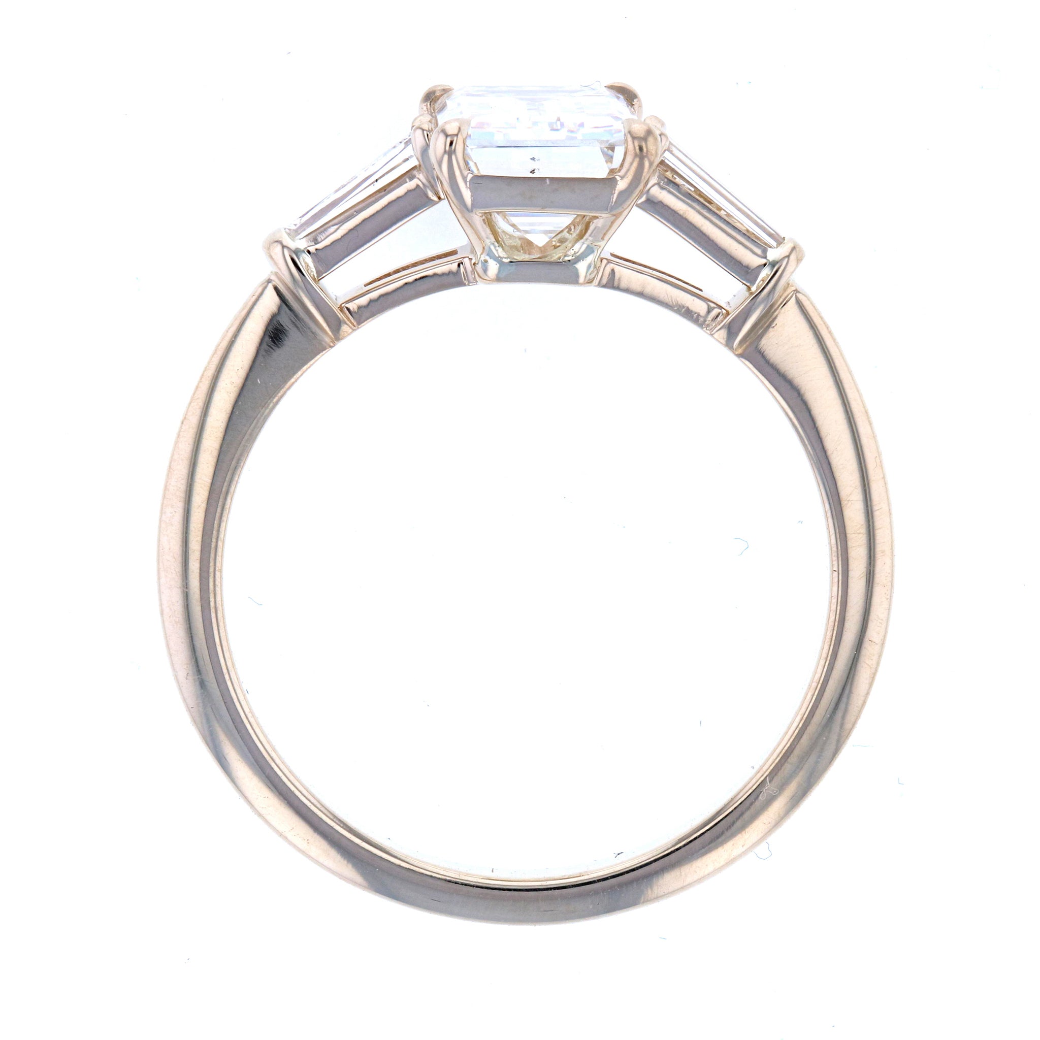 Emerald Cut Diamond Engagement Ring in Three Stone Setting with Tapered Baguettes